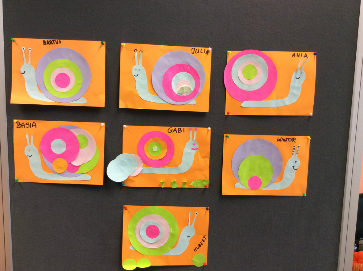 Na tablicy wisi siedem prac plastycznych dzieci, kolorowe ślimaki.