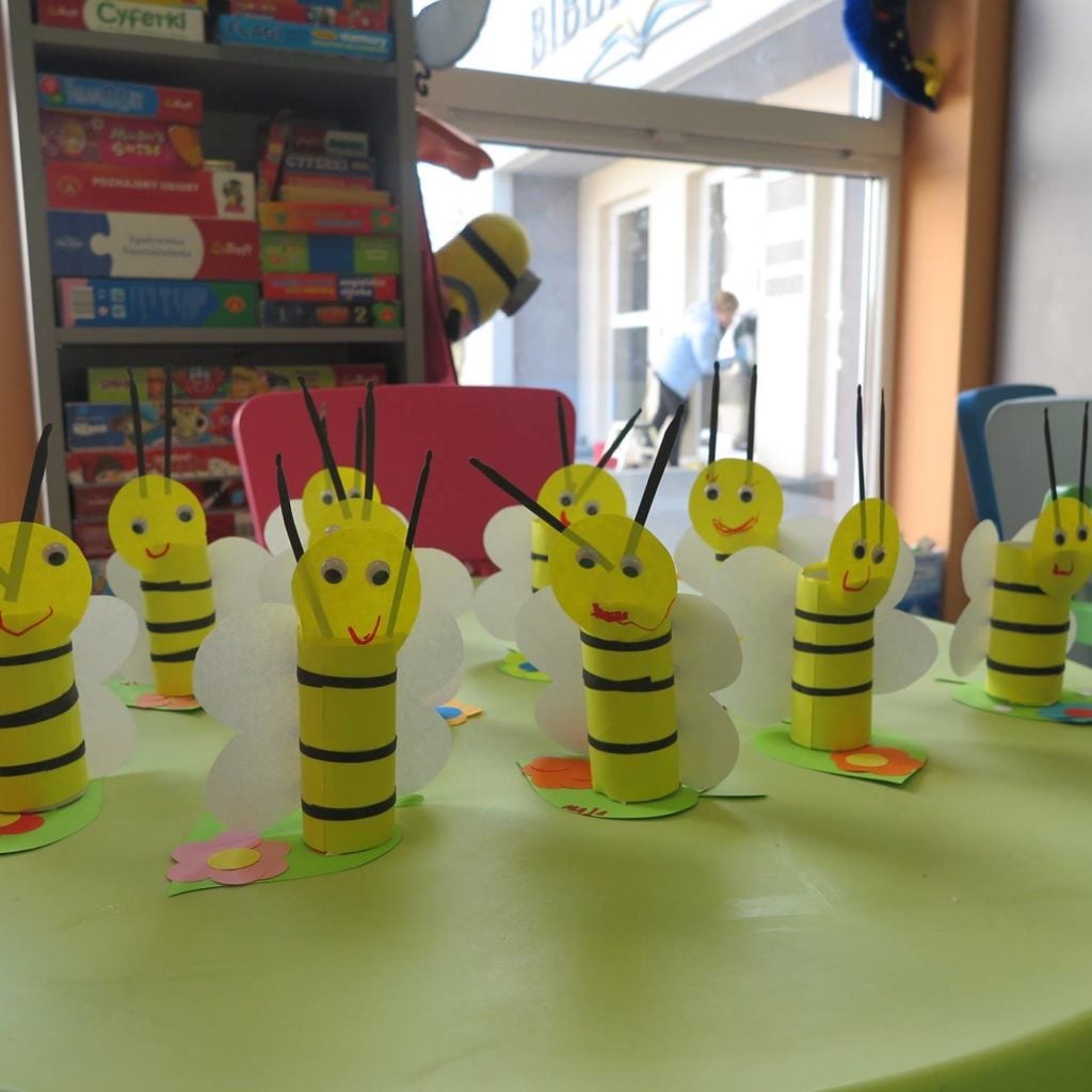 Na stoliku stoją papierowe pszczółki wykonane przez dzieci z wcześniej przygotowanych elementów.