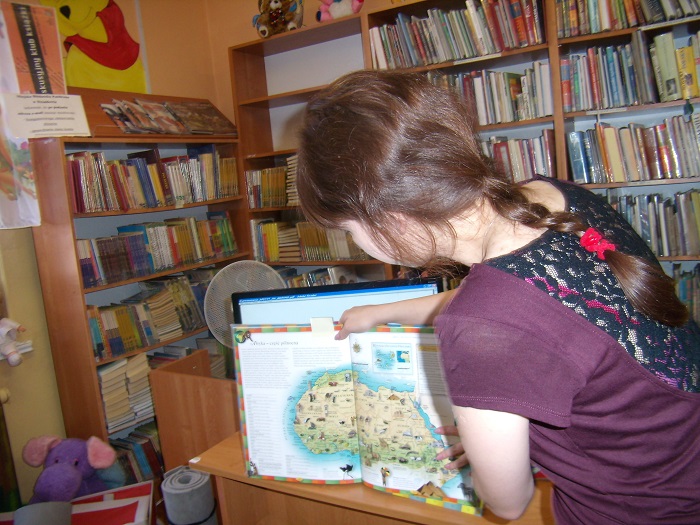 Studentka II roku filologii polskiej UWM pokazuje dzieciom mapę.
