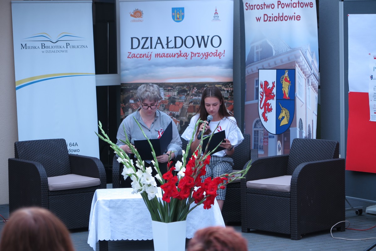 Na kanapie przed MBP w Działdowie dwie młode dziewczyny czytają powieść ,,Przedwiośnie''.