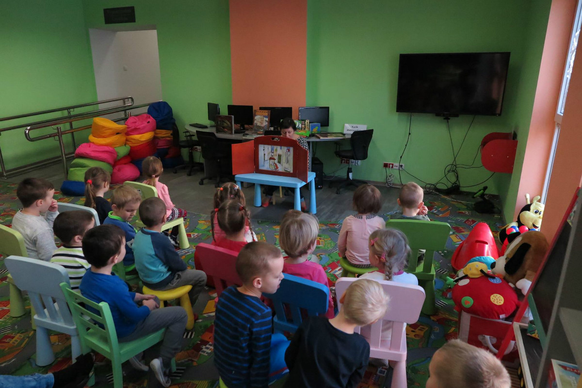 Grupa dzieci słucha teatrzyku Kamishibai "Pani Zamieć" .