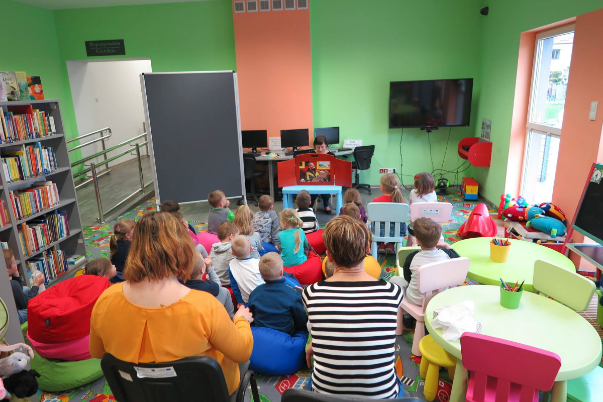 Bibliotekarka Ania Wiśniewska czyta dzieciom  teatrzyk Kamishibai "Słowik".