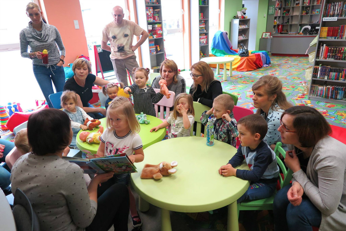 Bibliotekarka Ania Wiśniewska czyta dzieciom książkę "Zając i żółw".